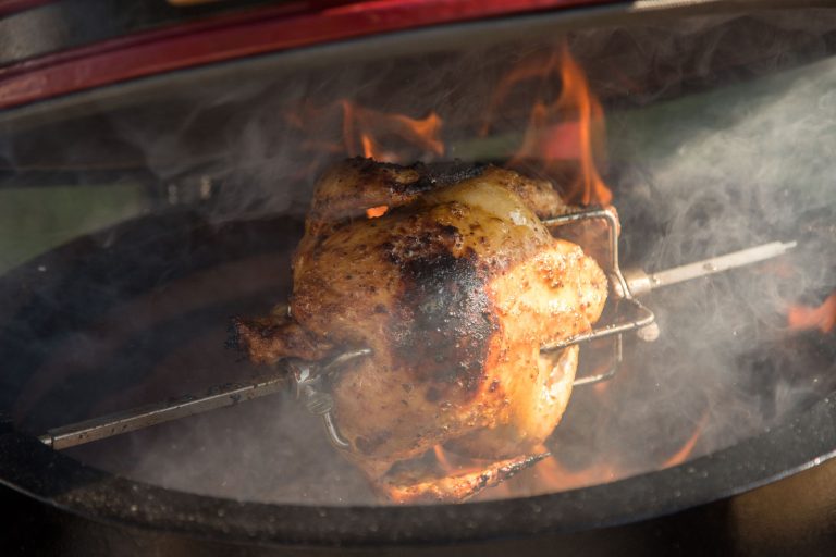 Turning over the coals – The spit turns by itself, so the chicken browns evenly